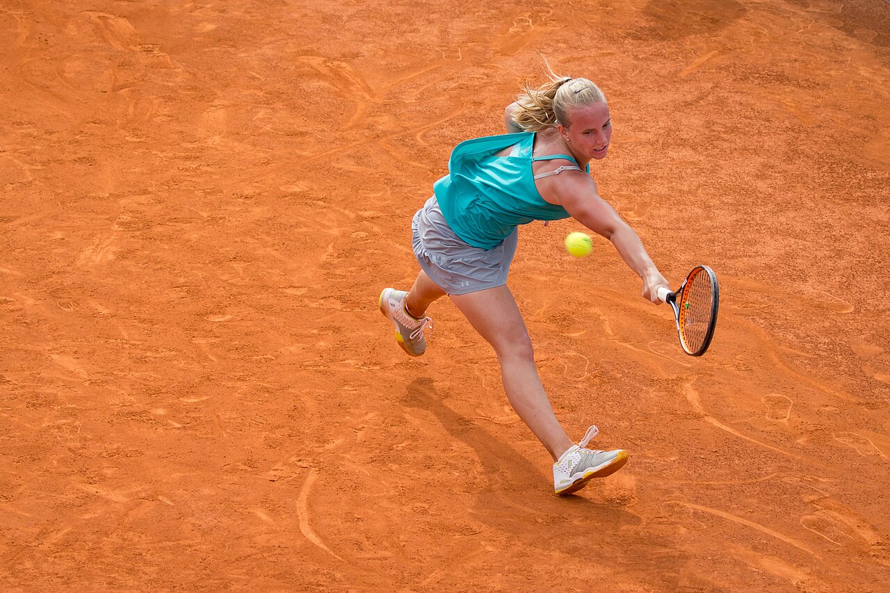 Người chơi tennis thực hiện cú đánh trên sân đất nện